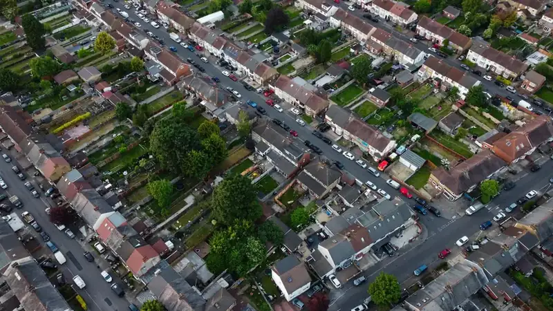 Aerial view of English terraced streets with long back gardens, rear additions and parked cars