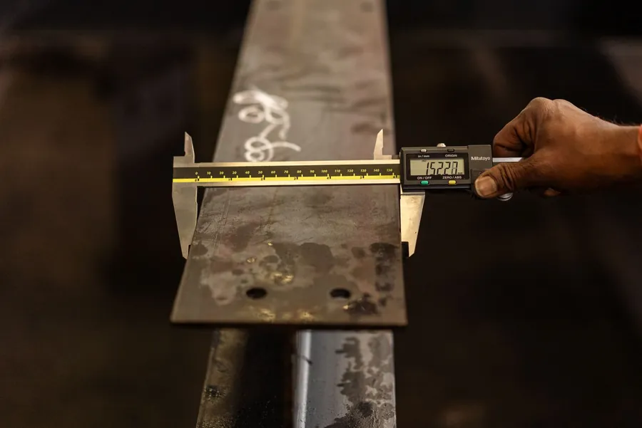 Digital caliper measuring the thickness of a sheet of metal, the measurement that separates one code of lead from the next