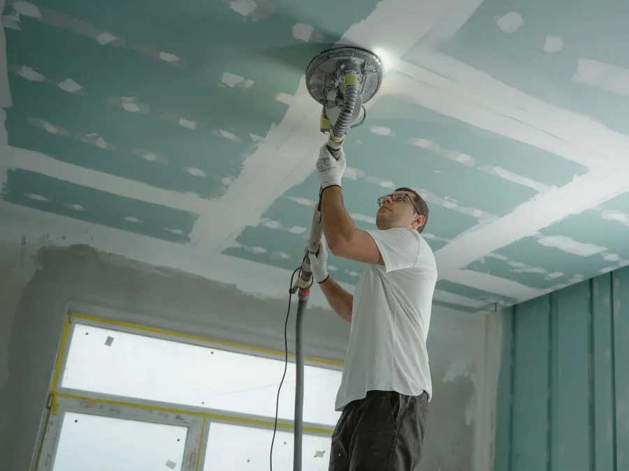 Plasterboard ceiling being made good after water damage from a roof leak in Croydon