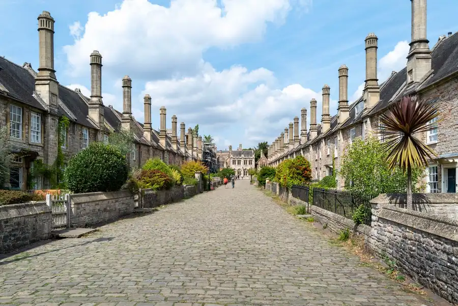 Historic street of listed stone houses with tall chimney stacks, the kind of roofline conservation area rules protect