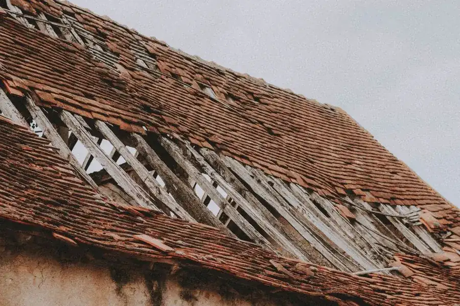 Displaced roof tiles exposing the timber battens underneath
