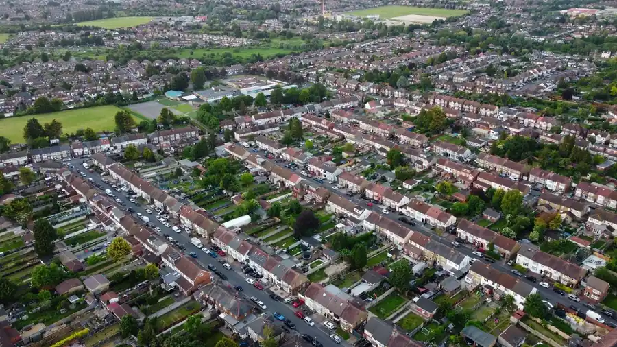 Aerial view of rows of interwar semi-detached houses with hipped tiled roofs
