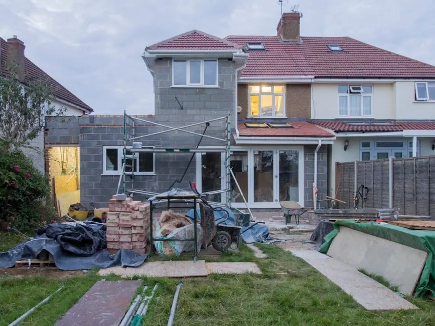 The rear of a British terraced house with a back addition and small garden