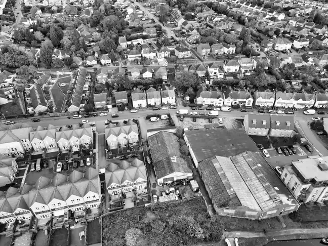 Aerial view of rows of semi-detached houses and their tiled roofs on suburban streets