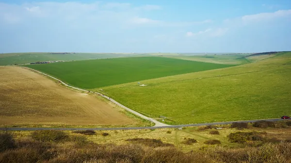 Open chalk downland with a path running across grassy slopes