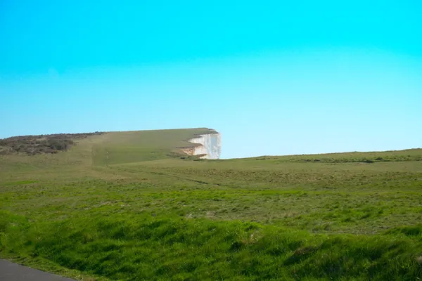 Rolling chalk downland grass rising to a high open ridge
