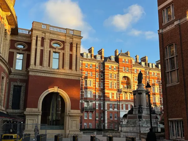 Ornate Victorian red brick building with a stone archway and decorative facade